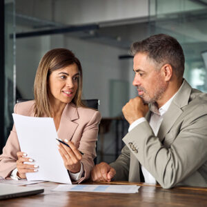 Two professionals going over revenue report